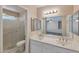 This bathroom features a double sink vanity, shower and tile flooring at 825 E Michigan Ave, Phoenix, AZ 85022