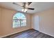 Inviting bedroom featuring wood floors, a ceiling fan, and a large window at 825 E Michigan Ave, Phoenix, AZ 85022