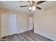 Cozy bedroom featuring wood floors, a ceiling fan and closet at 825 E Michigan Ave, Phoenix, AZ 85022