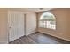 Bright bedroom with wood floors, arched window and closet with sliding doors at 825 E Michigan Ave, Phoenix, AZ 85022
