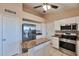 Well-equipped kitchen with white cabinets, granite counters, and stainless steel appliances at 825 E Michigan Ave, Phoenix, AZ 85022