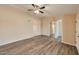 Open living room featuring wood-look floors, neutral walls, and arched doorways at 825 E Michigan Ave, Phoenix, AZ 85022