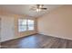 Bright living room featuring wood-look floors, a ceiling fan, and ample natural light at 825 E Michigan Ave, Phoenix, AZ 85022