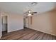 This is a light and open main bedroom with wood floors and a ceiling fan at 825 E Michigan Ave, Phoenix, AZ 85022