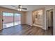 Main bedroom with wood-look floors, ensuite bathroom, and sliding door to backyard at 825 E Michigan Ave, Phoenix, AZ 85022