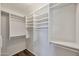 Walk-in closet with built-in shelving, maximizing storage and organization at 825 E Michigan Ave, Phoenix, AZ 85022
