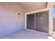 This covered back patio showcases sliding door entry to the home with modern outdoor lighting at 830 S Cerise --, Mesa, AZ 85208
