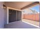 A covered back patio with sliding door entry provides access to the gravel backyard and home at 830 S Cerise --, Mesa, AZ 85208