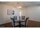 Dining room with a glass table, four chairs, neutral decor and an adjacent hallway at 830 S Cerise --, Mesa, AZ 85208