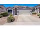 Inviting home exterior with desert landscaping, a two-car garage, and a welcoming entrance at 830 S Cerise --, Mesa, AZ 85208