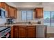 Modern kitchen with stainless steel dishwasher and a view of the backyard through the window at 830 S Cerise --, Mesa, AZ 85208