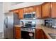 Spacious kitchen with stainless steel appliances and attractive wood cabinets for storage at 830 S Cerise --, Mesa, AZ 85208