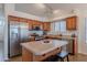 Bright kitchen with stainless steel refrigerator, an island, and ample cabinet space at 830 S Cerise --, Mesa, AZ 85208