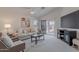 Living area with vaulted ceiling, fireplace, and sliding glass door at 830 S Cerise --, Mesa, AZ 85208