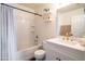 Well-lit bathroom featuring a shower and tub combination and white vanity with gold fixtures at 8516 N 64Th Ave, Glendale, AZ 85302