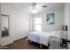 Bright bedroom featuring wood floors, a ceiling fan, closet, and a window with white blinds at 8516 N 64Th Ave, Glendale, AZ 85302