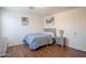 Bedroom featuring hard wood floor, neutral paint, and a matching dresser and nightstand at 8516 N 64Th Ave, Glendale, AZ 85302