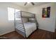 Bedroom with wood floors featuring a bunk bed, ceiling fan, and Zelda poster at 8516 N 64Th Ave, Glendale, AZ 85302