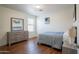 Bedroom featuring hard wood floor, neutral paint, and a matching dresser and nightstand at 8516 N 64Th Ave, Glendale, AZ 85302