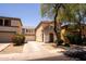 Exterior view of a two-story home with a two-car garage, front yard, and desert landscaping at 8516 N 64Th Ave, Glendale, AZ 85302