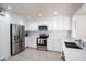 Updated kitchen featuring stainless steel appliances, white cabinetry and tile floors at 8516 N 64Th Ave, Glendale, AZ 85302