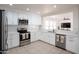 Bright kitchen with white cabinets, stainless steel appliances, and quartz countertops at 8516 N 64Th Ave, Glendale, AZ 85302