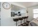 Open-concept kitchen with white cabinets, breakfast bar, and stainless steel appliances at 8516 N 64Th Ave, Glendale, AZ 85302
