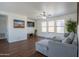 Open concept living room with hardwood floors, ample natural light and sectional couch at 8516 N 64Th Ave, Glendale, AZ 85302