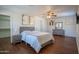 Spacious primary bedroom with hardwood floors, ceiling fan, and ensuite bathroom at 8516 N 64Th Ave, Glendale, AZ 85302