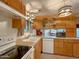 Well-lit kitchen featuring white appliances and classic cabinetry at 8600 E Broadway Rd # 88, Mesa, AZ 85208