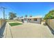 Spacious backyard with artificial grass, desert landscaping, mature palm trees at 907 E Broadmor Dr, Tempe, AZ 85282