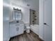 Updated bathroom boasts modern vanity, wood-look floors, tiled shower and tub at 907 E Broadmor Dr, Tempe, AZ 85282