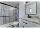 Updated bathroom with marble counters, modern fixtures, and a sleek glass shower enclosure at 907 E Broadmor Dr, Tempe, AZ 85282