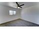 Bright bedroom features neutral carpet, ceiling fan, and a window for ample natural light at 907 E Broadmor Dr, Tempe, AZ 85282
