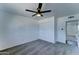 Bedroom features neutral carpet, ceiling fan, closet doors, and hallway entrance at 907 E Broadmor Dr, Tempe, AZ 85282