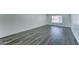 Clean bedroom featuring gray wood flooring, neutral paint and lots of light at 907 E Broadmor Dr, Tempe, AZ 85282