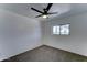 Bright bedroom features neutral carpet, ceiling fan, and a window for ample natural light at 907 E Broadmor Dr, Tempe, AZ 85282
