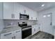 Updated kitchen with stainless steel appliances, sleek white cabinets, and granite countertops at 907 E Broadmor Dr, Tempe, AZ 85282