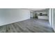 Living area featuring gray wood floors and a kitchen with stainless steel appliances at 907 E Broadmor Dr, Tempe, AZ 85282