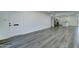 Open living area featuring gray wood flooring, neutral paint, and a kitchen area at 907 E Broadmor Dr, Tempe, AZ 85282