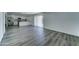 Spacious living room boasts wood floors, modern fixtures, and flows into an updated kitchen with stainless appliances at 907 E Broadmor Dr, Tempe, AZ 85282