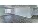 Open-concept living area with lots of light, featuring neutral paint and gray wood flooring at 907 E Broadmor Dr, Tempe, AZ 85282