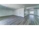 Open-concept living area featuring gray wood floors, neutral paint, and recessed lighting at 907 E Broadmor Dr, Tempe, AZ 85282