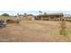 Expansive backyard with brick perimeter, desert landscaping, and covered patio at 9157 W Gary Rd, Peoria, AZ 85345
