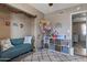 Cozy room with blue sofa and neatly organized shelves for toys at 9157 W Gary Rd, Peoria, AZ 85345