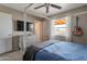 Relaxing bedroom with a four-poster bed, ceiling fan, and a view to the backyard at 9157 W Gary Rd, Peoria, AZ 85345