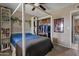 Spacious bedroom featuring a four-poster bed, built-in shelves, and an organized closet area at 9157 W Gary Rd, Peoria, AZ 85345