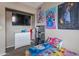 Cozy bedroom with colorful bedding, decorative posters, and a mounted TV at 9157 W Gary Rd, Peoria, AZ 85345