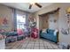 Playful room with a blue sofa, stuffed animals, and a cozy area rug at 9157 W Gary Rd, Peoria, AZ 85345