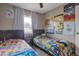 Shared room showcasing twin beds with themed bedding and playful decor at 9157 W Gary Rd, Peoria, AZ 85345